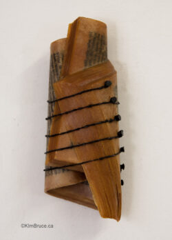 Henigman Bruce - 6th String Missing, Encaustic, string, furniture tacks on a book, 5.5"h x 2.5"w x 1.25"d overall Henigman Bruce - 6th String Missing