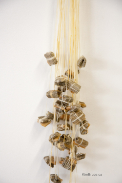 Henigman Bruce - Spill - Encaustic medium, book pages, thread, copper, silver, brass - 18h x 5w x 4.5d Henigman Bruce - Spill